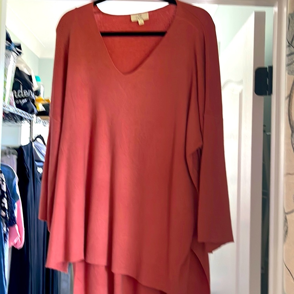 Salmon color v neck sweater with a longer back than front